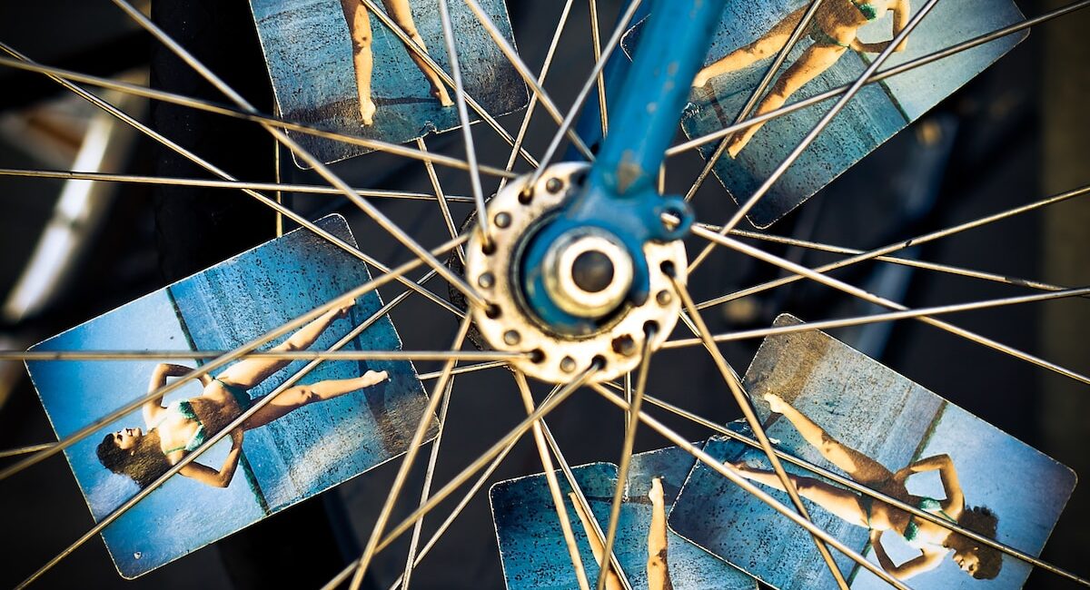 blue and grey bicycle wheel with photo of woman