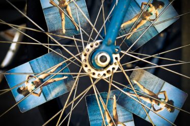blue and grey bicycle wheel with photo of woman