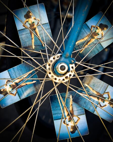 blue and grey bicycle wheel with photo of woman